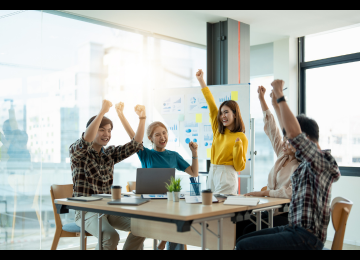 People in an office celebrating their success