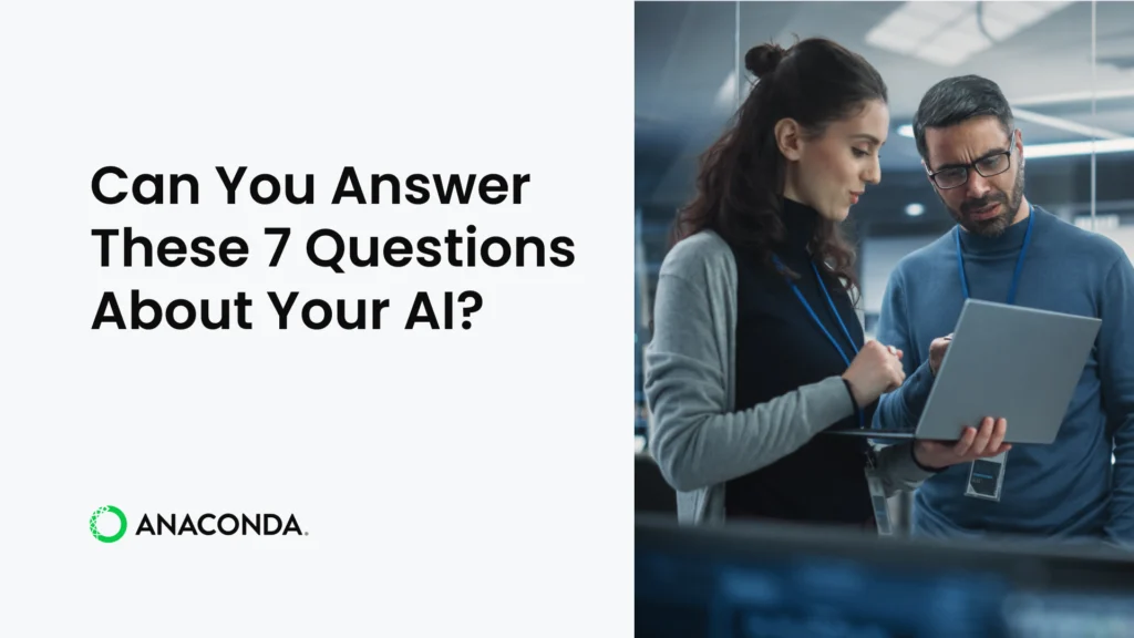 Two professionals review information on a laptop together in a modern office environment, alongside the text "Can You Answer These 7 Questions About Your AI?" and the Anaconda logo.